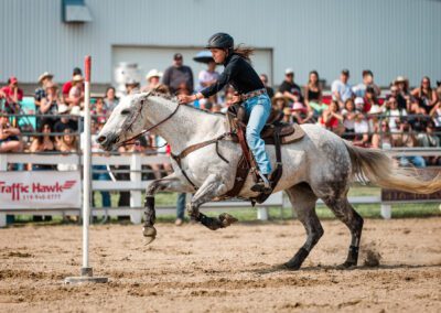 Action and sports photography of pole bending at the 2025 Headwaters Ram Rodeo at Orangeville Fairgrounds by Frank Myrland Photography
