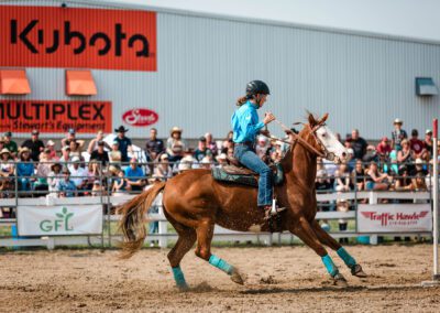 Action and sports photography of pole bending at the 2025 Headwaters Ram Rodeo at Orangeville Fairgrounds by Frank Myrland Photography