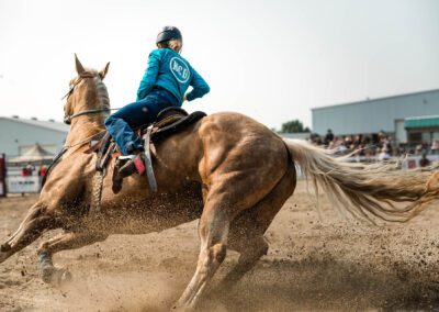 Action and sports photography of horse barrel riding at the 2025 Headwaters Ram Rodeo at Orangeville Fairgrounds by Frank Myrland Photography