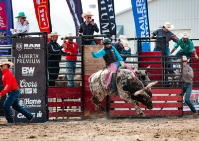 Action and sports photography of bull riding at the 2025 Headwaters Ram Rodeo at Orangeville Fairgrounds by Frank Myrland Photography