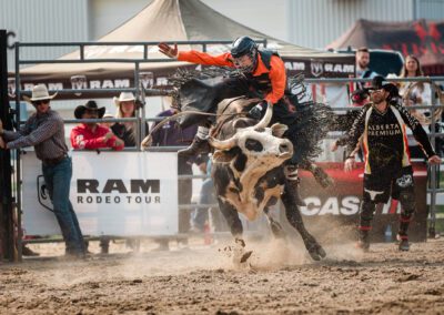 Action and sports photography of bull riding at the 2025 Headwaters Ram Rodeo at Orangeville Fairgrounds by Frank Myrland Photography