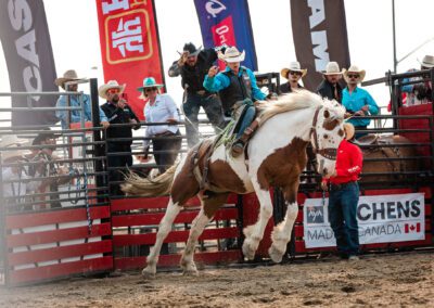 Action and sports photography of bucking broncos at the 2025 Headwaters Ram Rodeo at Orangeville Fairgrounds by Frank Myrland Photography