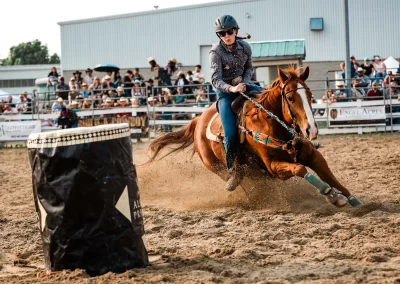 Action and sports photography of horse barrel racing at the 2025 Headwaters Ram Rodeo at Orangeville Fairgrounds by Frank Myrland Photography