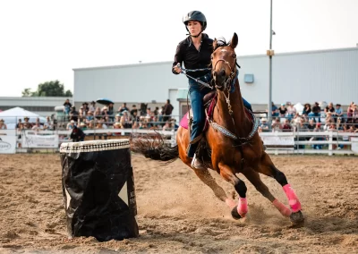 Action and sports photography of horse barrel racing at the 2025 Headwaters Ram Rodeo at Orangeville Fairgrounds by Frank Myrland Photography