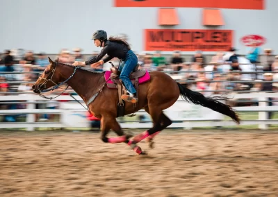 Action and sports photography of horse barrel racing at the 2025 Headwaters Ram Rodeo at Orangeville Fairgrounds by Frank Myrland Photography