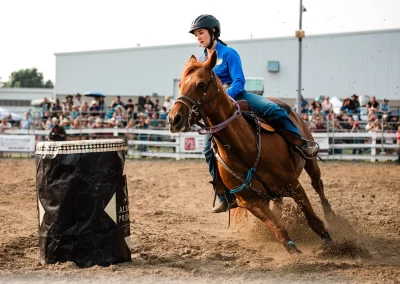 Action and sports photography of horse barrel racing at the 2025 Headwaters Ram Rodeo at Orangeville Fairgrounds by Frank Myrland Photography
