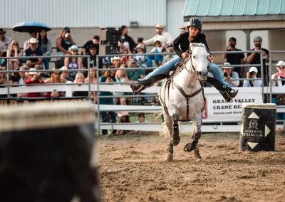 Action and sports photography of horse barrel racing at the 2025 Headwaters Ram Rodeo at Orangeville Fairgrounds by Frank Myrland Photography