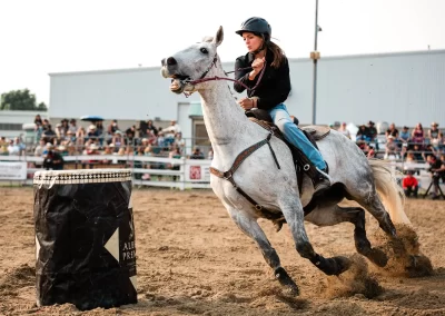 Action and sports photography of horse barrel racing at the 2025 Headwaters Ram Rodeo at Orangeville Fairgrounds by Frank Myrland Photography