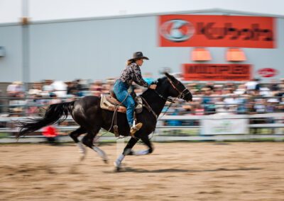 Action and sports photography of horse barrel racing at the 2025 Headwaters Ram Rodeo at Orangeville Fairgrounds by Frank Myrland Photography