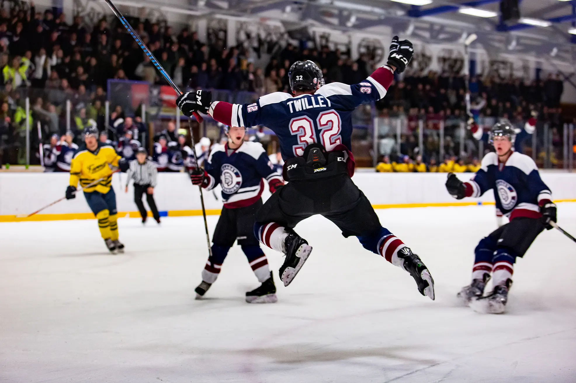 Action photo of a hockey player celebrating a goal taken by Frank Myrland Photography
